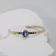 Deep blue sapphire bracelet in hammered Argentium silver with fused gold — classic and serene.