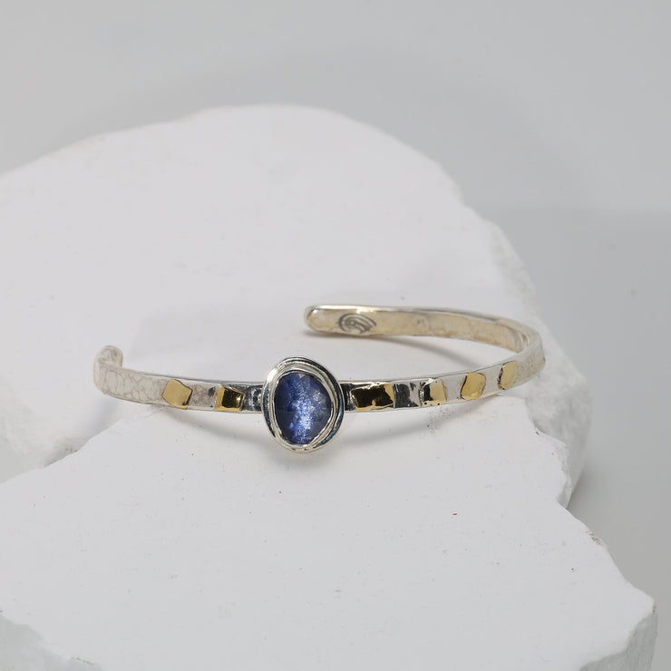 Deep blue sapphire bracelet in hammered Argentium silver with fused gold — classic and serene.