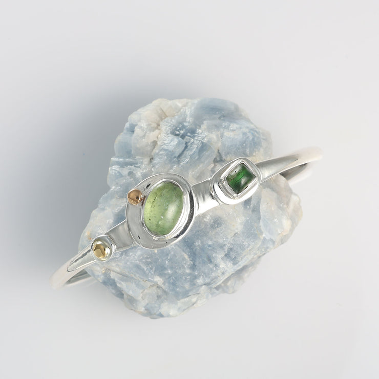Handcrafted mixed metal cuff bracelet by Breathe Autumn Rain featuring an organic open-band design and natural green gemstones.