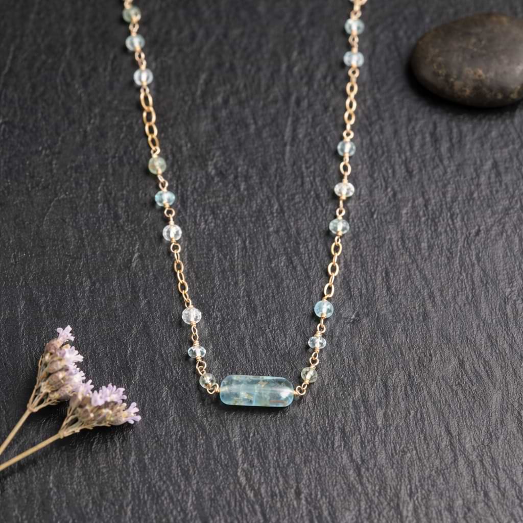 Close-up macro shot of the faceted aquamarine beads and the organic aquamarine nugget bar showing the gold wire wrapping details.