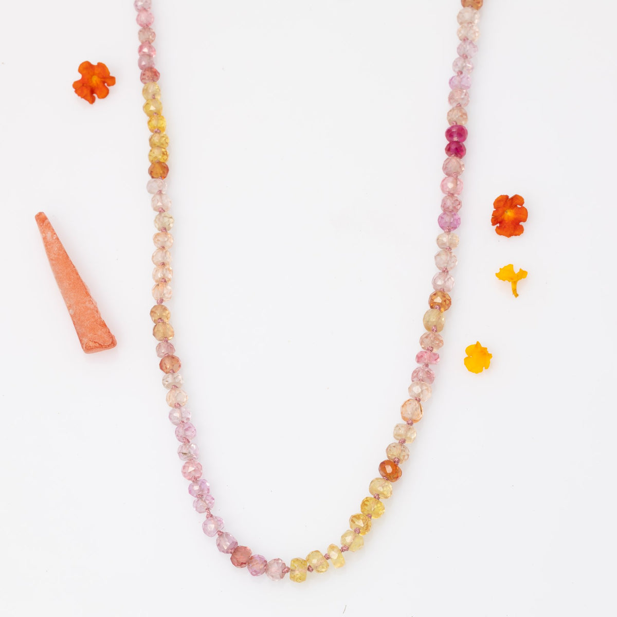  Peonies in Bloom padparadscha sapphire necklace laid flat showing full length and color range – Breathe Autumn Rain