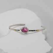 Romantic pink sapphire cuff bracelet in hammered Argentium silver with fused gold accents.