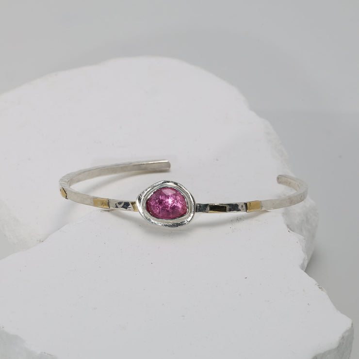 Romantic pink sapphire cuff bracelet in hammered Argentium silver with fused gold accents.
