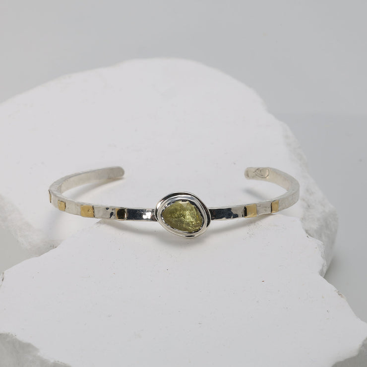 Bright yellow sapphire cuff bracelet symbolizing joy, handcrafted in silver and gold.